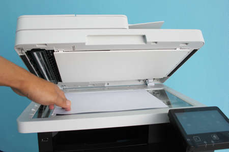 Bussiness man Hand press button on panel of printer, printer scanner laser office copy machine...