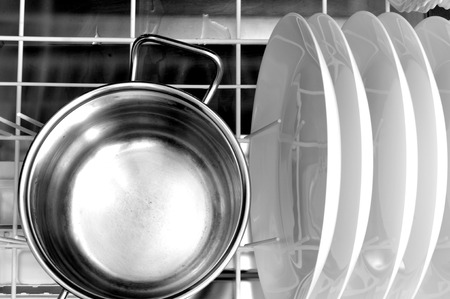 clean dishes and a steel pot in the dishwasherの写真素材