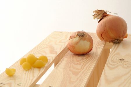 Raw pasta and onions,  on white backgroundの写真素材