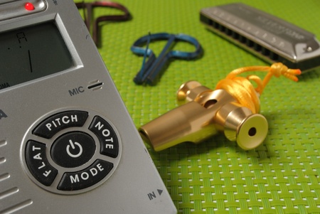 A jew s harp, a harmonica, a samba whistle, an electronic tuner, four musical instruments to learn...