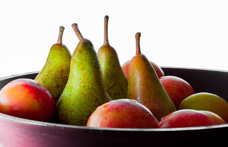 basket with pears, peaches and other tasty fruitsの写真素材