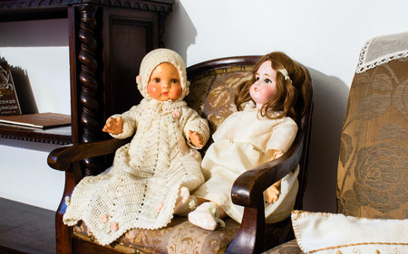 Doll blankly and disturbing and sitting on a sofaの写真素材