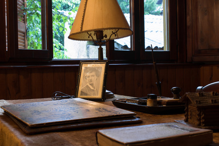 room dedicated to reading furnished with bookshelves and desks in old wood