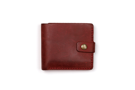 Closed red leather wallet on a white backgroundの写真素材