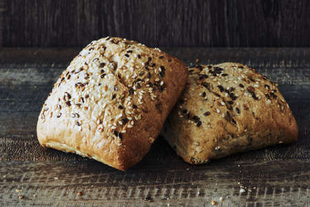 Wholemeal, rye, seed, nut and sesame buns and rolls for a breakfast with jam and coffee