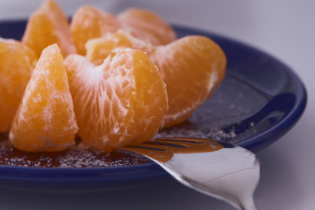 Orange clementines ready to be eaten. Orange fruit, fresh and natural. Fruit with or without sugar. Clementines in blue dishes.の写真素材