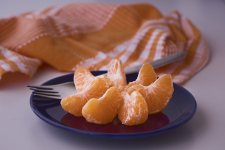 Orange clementines ready to be eaten. Orange fruit, fresh and natural. Fruit with or without sugar. Clementines in blue dishes.の写真素材