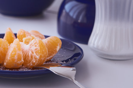 Orange clementines ready to be eaten. Orange fruit, fresh and natural. Fruit with or without sugar. Clementines in blue dishes.の写真素材