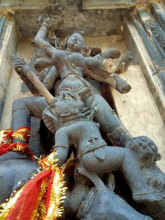 Mythological goddess sculptured oh the stone wall of the templeの写真素材