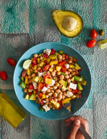 Top view of East Balela salad with chickpea, avocado, feta cheese, cherry tomato, onions. Mediterranean cuisine.の写真素材