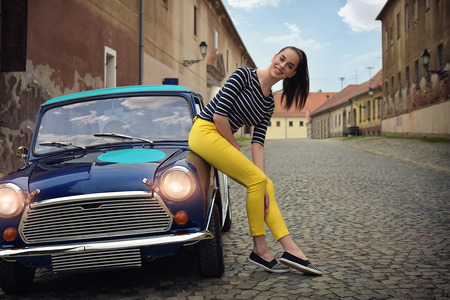 mini car vintage and happy girlの写真素材