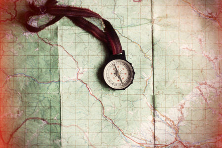 wanderlust and explore concept, compass on map, top view, vintage toned image, space for text