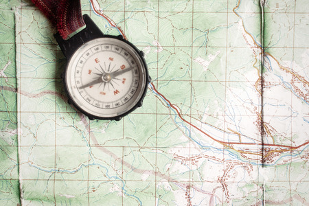 wanderlust and explore concept, old compass lying on map, top view, space for text, vintage toned imageの写真素材