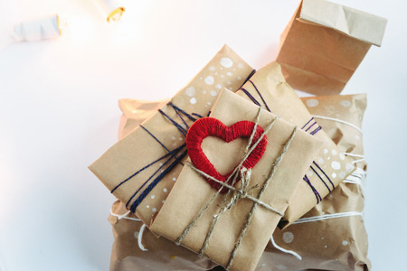 Stylish craft presents with red heart, happy valentine's day, holiday greeting card concept