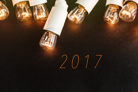 2017 sign on black background with unusual christmas golden vintage garland lights, happy new year,...