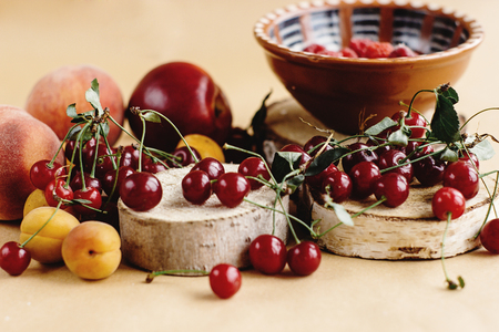 delicious cherry and fruits on wooden background, rustic summer concept, colorful wallpaperの写真素材