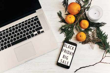 black friday sale. special offer discount text on mobile phone screen on seasonal rustic backgroundの写真素材