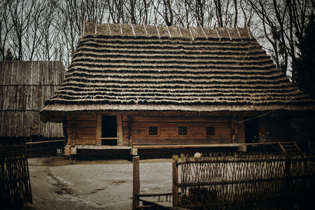 Old wooden building in retro slavic village, traditional countryside house with straw roof in national parkの写真素材