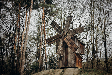 Rustic old windmill in ukrainian national architecture park, wooden mill in a forest slavic farm in the countryside, agriculture conceptの写真素材