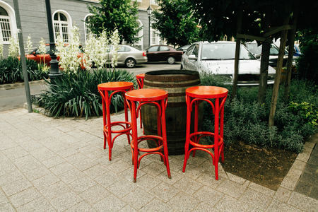 unusual red chairs and wooden barrel, setting in street cafe, creative service in Budapest city, travel conceptの写真素材