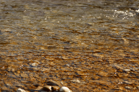 beautiful view at water surface at river, in spring or autumn mountains, brown wallpaperの写真素材