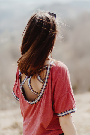 beautiful stylish woman hipster smiling and having fun in sunny mountains, cheerful moment of happinessの写真素材