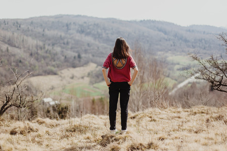 happy stylish hipster woman standing on top of hill mountain, cheerful moment of happinessの写真素材