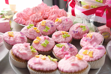 luxury delicious pink cupcakes and candy bar at celebration, party in a restaurantの写真素材