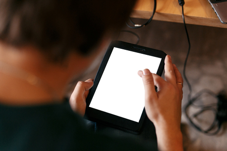 stylish man holding tablet with empty white screen and touching, sitting at meeting, business marketing lecture coachingの写真素材