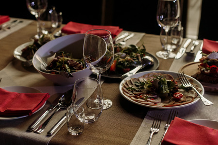Delicious meals at wedding reception table close-up, vegetable plate at banquet near meat dishes and wine glasses, fine dining conceptの写真素材