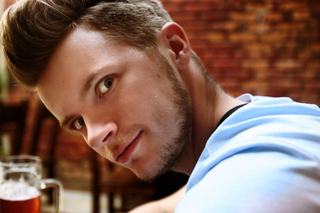 happy stylish man with funny crazy look and emotion, having fun in restaurantの写真素材