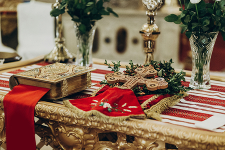 golden bible and cross on altar  in church. traditional wedding ceremony, space for text. religionの写真素材