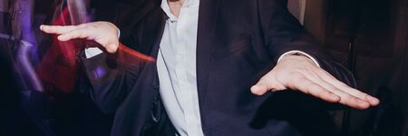 man dancing at funny wedding party. guests having fun and dance at luxury wedding reception. joyful moments. light show. space for textの写真素材