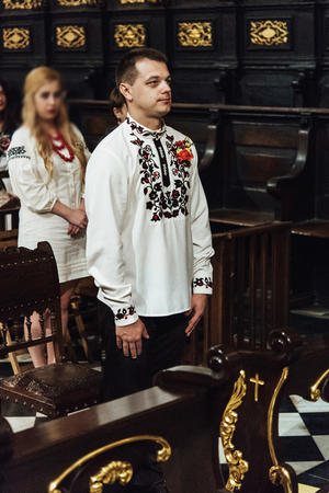 wedding ceremony of stylish elegant brunette bride and groom in the old churchの写真素材