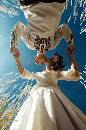 beautiful brunette bride and elegant stylish groom with true happy feelings kissing in a sunny...