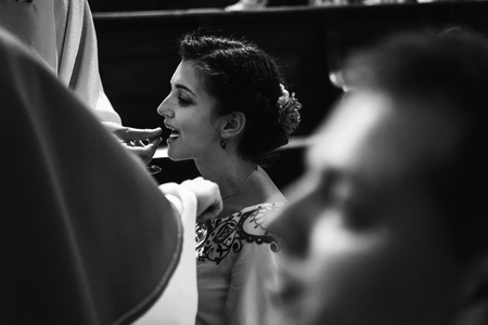 wedding ceremony of stylish elegant brunette bride and groom in the old churchの写真素材