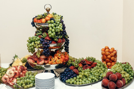 fruits bar, wedding table with fresh food in restaurant, luxury wedding reception, stylish decor and cateringの写真素材