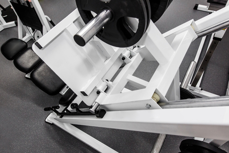 dumbbells, modern gym weight training equipment for exercises and rehab, leg presses. rehabilitation equipment in therapy clinic. fitness wellness concept. space for text.の写真素材