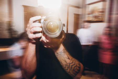 man holding photo camera, photographer at wedding ceremony reception,