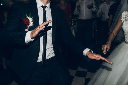 bride and groom dancing, having fun. wedding couple dance at wedding reception in restaurant. people at disco partyの写真素材