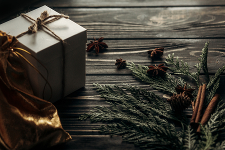 christmas simple present box and thread on stylish rustic wooden background with space for text. greeting card concept. seasonal greetings winter holidaysの写真素材