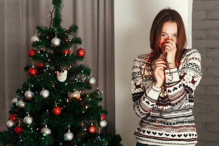 stylish woman in christmas lights posing and smiling at christmas tree in festive holiday time. joyful moments in winter. seasonal greetings concept. space for text
cozyの写真素材