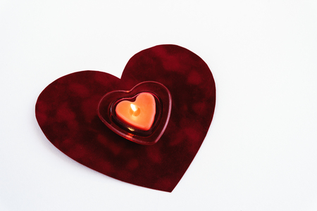 heart red candle on velvet isolated on white background, valentine greeting card conceptの写真素材