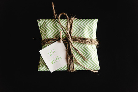 beautiful simple present in amazing green wrapping paper with greeting card, best wishes textの写真素材