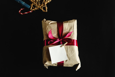 beautiful simple present in craft paper with crimson ribbon and a card, holiday conceptの写真素材