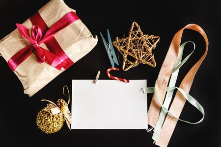 beautiful simple present in craft paper with ribbons, greeting card and toys, holiday conceptの写真素材
