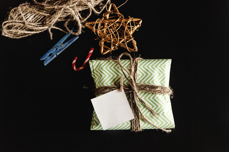 beautiful simple present in amazing green wrapping paper with greeting card, holiday concept