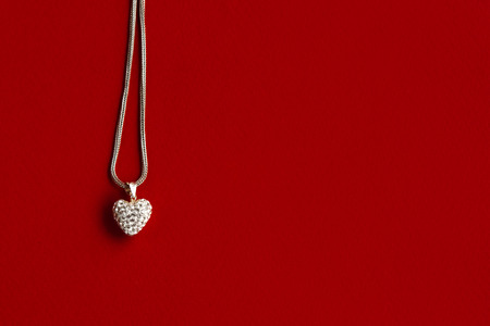 luxury heart necklace with stylish diamonds on red background, present and love concept, valentine's dayの写真素材