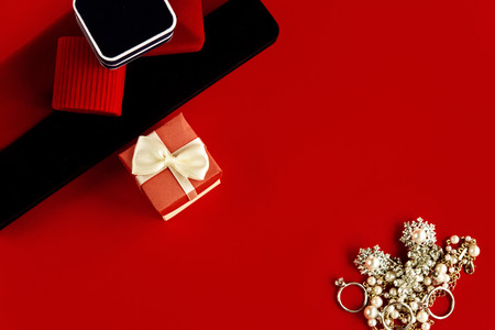 luxury ring and stylish necklace and gift box on red background, present and love concept, valentine's dayの写真素材