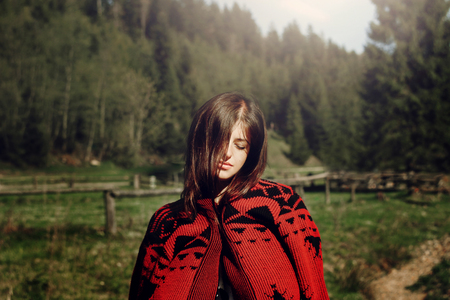 woman hipster relaxing at woods in summer mountains, travel wanderlust concept, space for text
